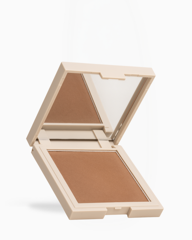 An open square makeup compact with a mirror on the lid and a pressed powder pan in a warm medium tan-brown shade, shown on a clean white background.