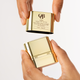 OGB Hydrate & Lift Duo: hands opening the gold face lift stick