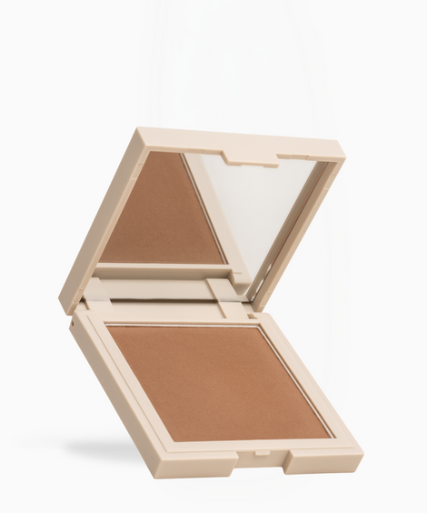 An open square makeup compact with a mirror on the lid and a pressed powder pan in a warm medium tan-brown shade, shown on a clean white background.