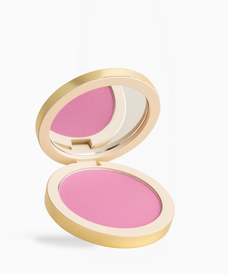 An open round makeup compact with a gold-toned case, showing a bright pink pressed powder and a mirror on a clean white background.