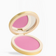 An open round makeup compact with a gold-toned case, showing a bright pink pressed powder and a mirror on a clean white background.